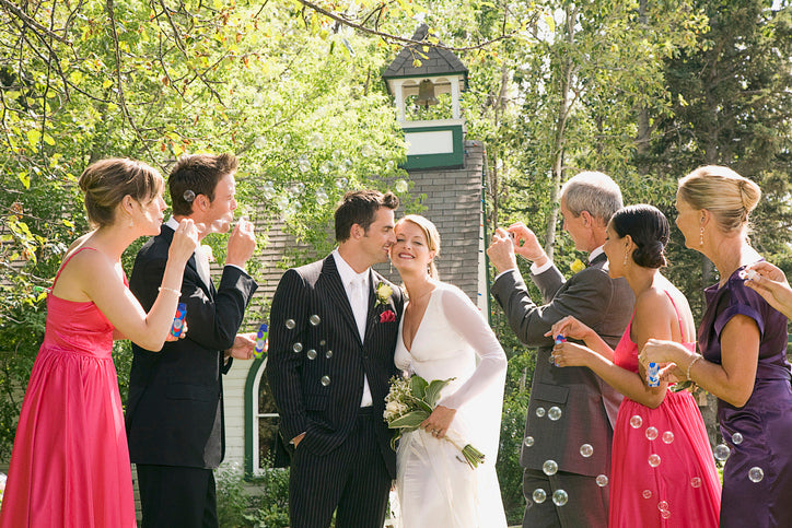 People blowing non-toxic bubbles at a wedding
